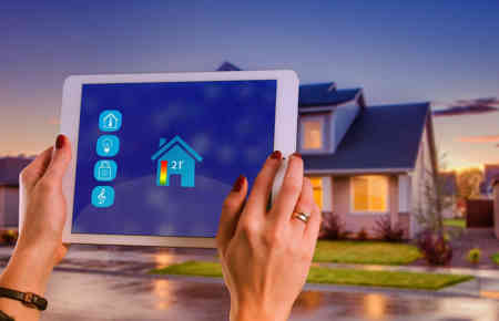 Person die mittels Smart Home Geräten das Energiemanagement des Hauses optimiert